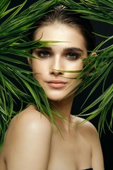 Beautiful woman green leaves exotic charm