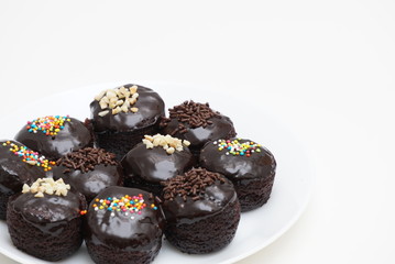 chocolate cupcakes decorated with patterns on top of cupcakes