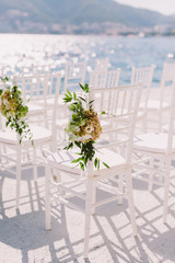 white wedding chairs outdoors venue