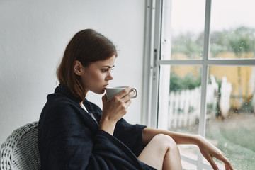 young woman sitting on a balcony