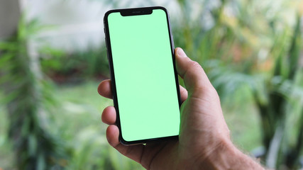 Man Watching A Smart Phone With Chroma Key Green Screen