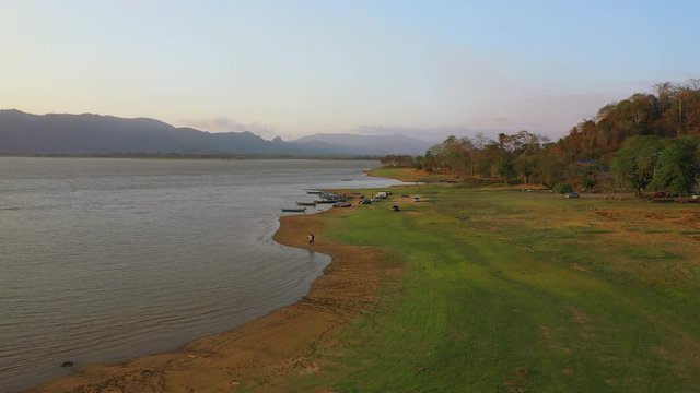 February 29th, 2020 - Perlis, Malaysia : 4k Establishing Aerial View Timah Tasoh Lake side During Beautiful Sunset with Mountain view. Drone Moving Forward