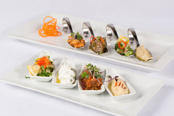 A variety ofAppetizer inside scoop with Oil