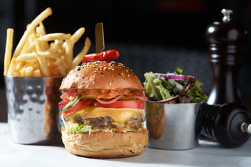 lobster roll on slate surface and burger