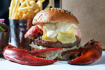lobster roll on slate surface and burger