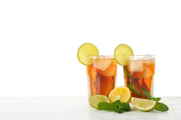 Glasses of tasty cold ice tea on white background