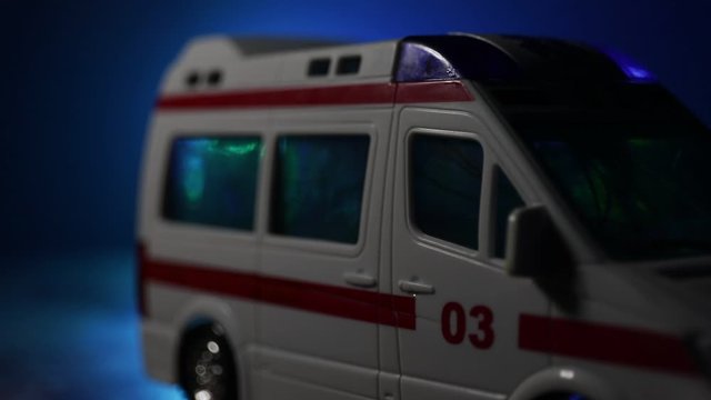 Corona virus concept with Ambulance car. Stay home for precautionary measures to prevent from corona virus. Ambulance car on dark misty background. Creative artwork decoration. Selective focus