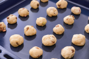 Baking tray with uncooked cookies, closeup