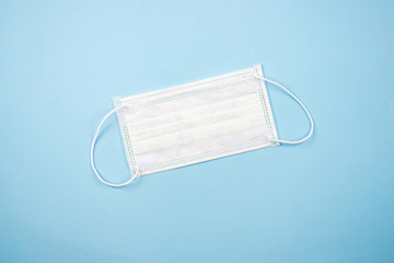 The top view of a face mask on a blue background. Isolated background.