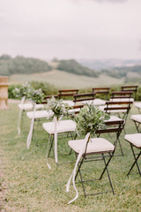 Fototapeta na wymiar wedding decoration chairs in rustic green style