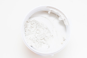 White acrylic glazing putty in a bucket on white background