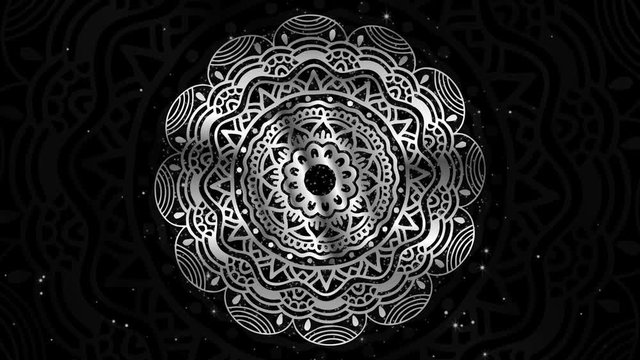 Premium rotating silver mandala royal design with flowing sparkling silver dust. Abstract Islamic style traditional floral design background with flying silver particles. LOOP BACKGROUND.