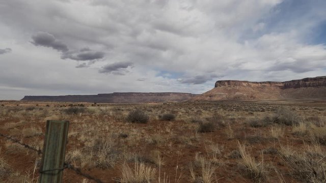 A wide timelapse of clouds flowing over fields in the Needles district of Canyonlands National Park.