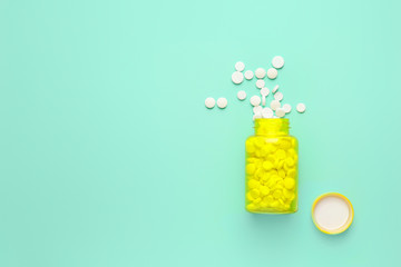 Bottle with pills on color background