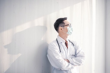 Portrait of Asian young male doctor standing