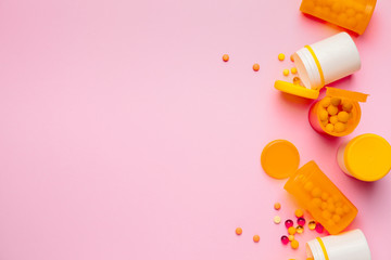 Bottles with pills on color background