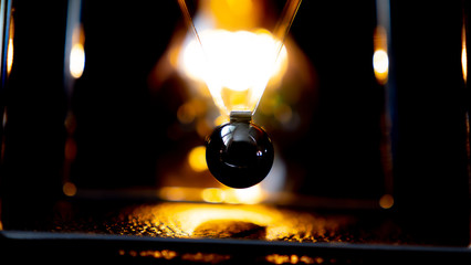 Newtons cradle metal ball moving on black background