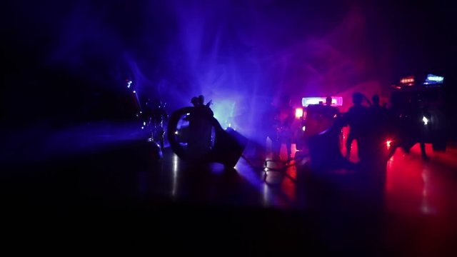 Corona virus concept with police. Stay home for precautionary measures to prevent from corona virus. Anti-riot police give signal to be ready. Smoke on a dark background with lights. Selective focus