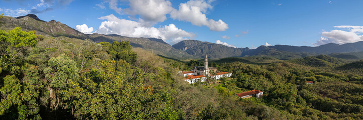 Aerial view panorama of Sanctuary Cara&ccedil;a with shadows, mountains, blue sky in background, Minas Gerais, Brazil