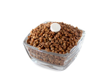 buckwheat in a bowl with tablet isolated on white