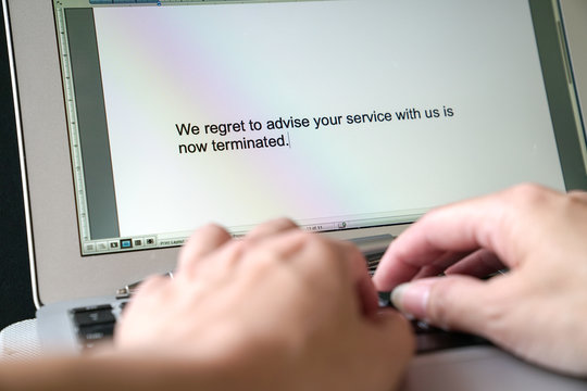 Woman typing letter of termination of service on the computer
