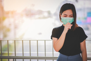 Fototapeta premium Asian woman wearing mask for protect pm2.5 and cough with Covid-19 virus outbreak in public.