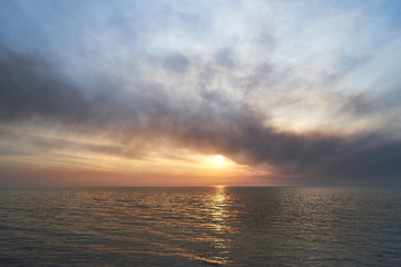 Fototapeta premium Sea sunset. Smoke wildfires sweeping across the sky.