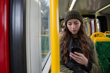 Young Woman Texting While She Rides the Melbourne Tram