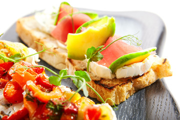 Tasty bruschetta with fish and baked peppers