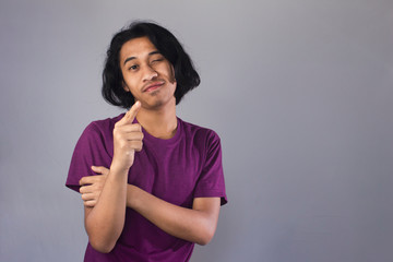 Fototapeta premium Young asian men with smart thinking gesture, using t-shirt ,isolated background. 