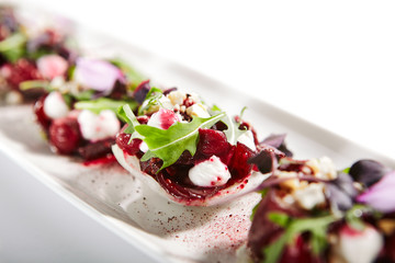 Beetroot tartare with goat cheese on tray