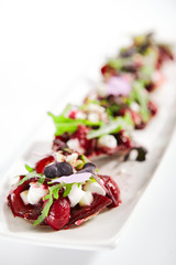 Beetroot tartare with goat cheese on tray