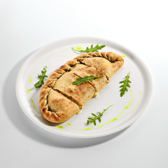 Calzone pizza with Parma ham, tomatoes and mozzarella