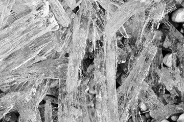 Ice crystal.  Transparent crystals are melting. Black and white photo. Close-up.