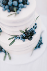 Obraz na płótnie Canvas white wedding cake with blueberry and blackberry
