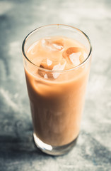 Iced coffee with cream on the rustic background. Selective focus. Shallow depth of field.