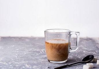 Fragrant custard with milk, spoon, sugar, concrete background.