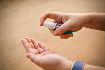 People using alcohol antiseptic gel and wearing prevention mask, prevent against infection of Covid 19 outbreak, woman washing hands with hand sanitizer to avoid contaminating with corona virus