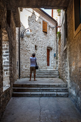 SIBENIK / CROATIA - AUGUST 2015: Narrow street in the historic centre of Sibenik town, Croatia