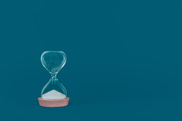 Hourglass with the finished sand. Concept of time and timely actions with place for text
