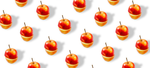 Trendy repeating pattern. Juicy red apples on a white background. Minimum summer concept. A banner from the same cut apples.