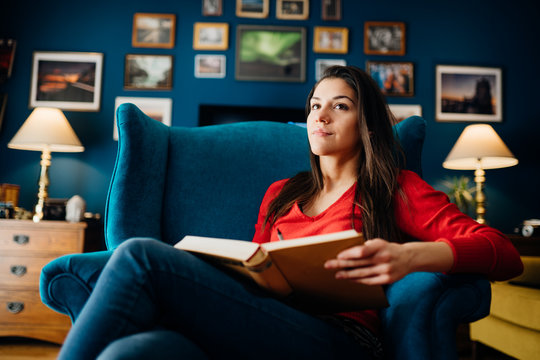 Woman enjoying reading an interesting book novel,home alone in quarantine.Mental health self care,relaxing home activity.Improving yourself,education motivation.Reducing stress.Booklover.Bookworm