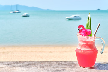 Colorful watermelon mocktail at the beach bar with sea background. Vacation, get away, summer outing concept