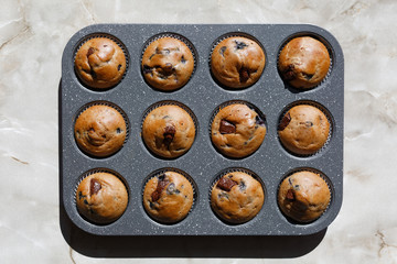 Chocolate muffins on table. Homemade cakes top view