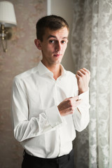 Beautiful man, groom posing and preparing for wedding