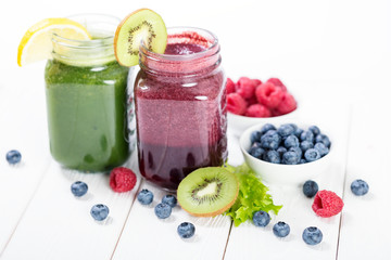 Berry and vegetables fresh smoothie in glass jars
