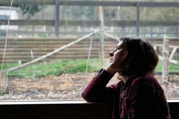Silhouette of woman gazing out of window