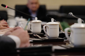 White tea mugs on the table during a business conference