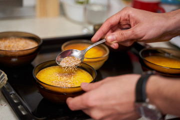 Pouring sugar over dessert