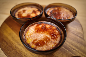 Creme brulee on wooden board
